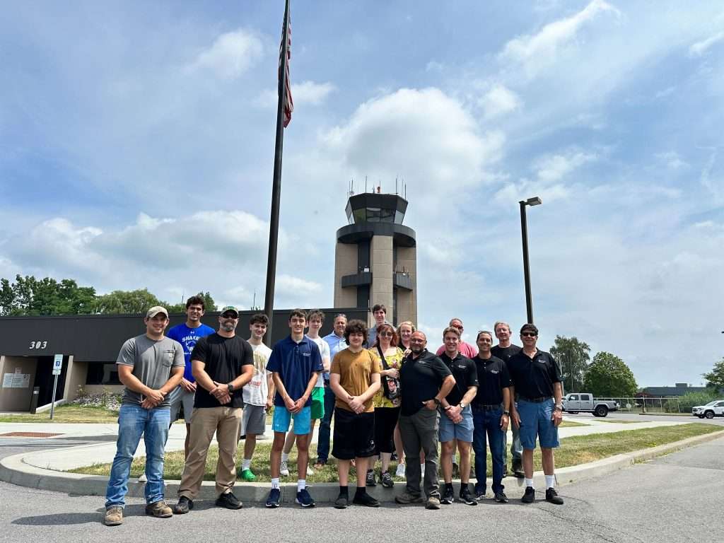 A group of Hewison students and instructors standing outside of the KALB control tower.